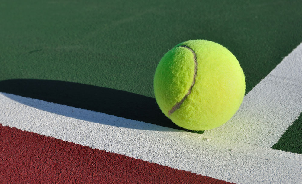 tennis ball on court baseline